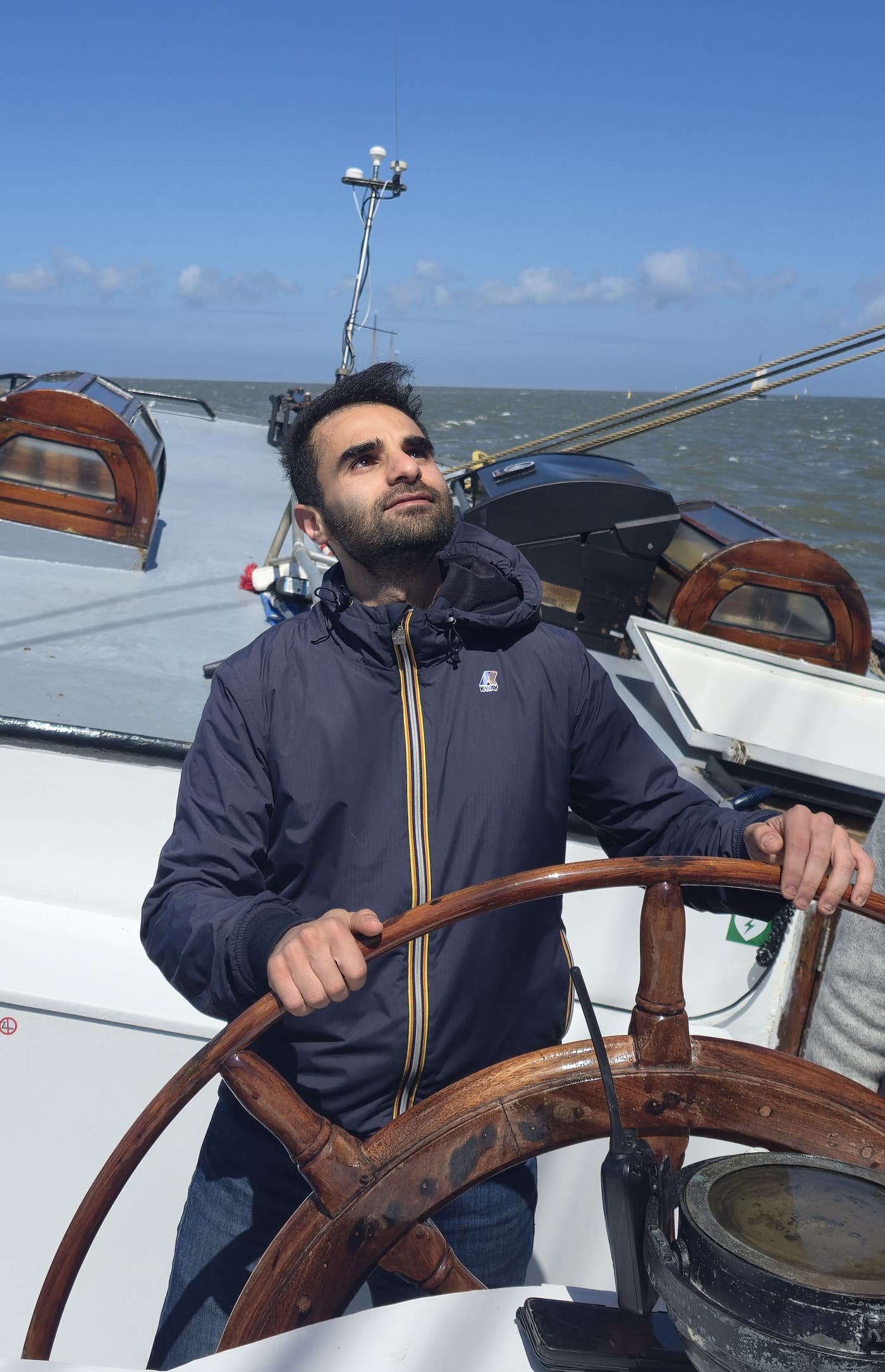 Mohamad at the helm of a sailboat